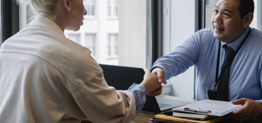 Ethnic businessman shaking hand of applicant in office
