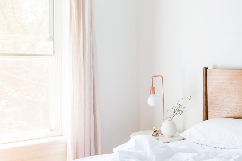 White table lamp and vase on side nightstand