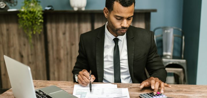 Man in black suit working