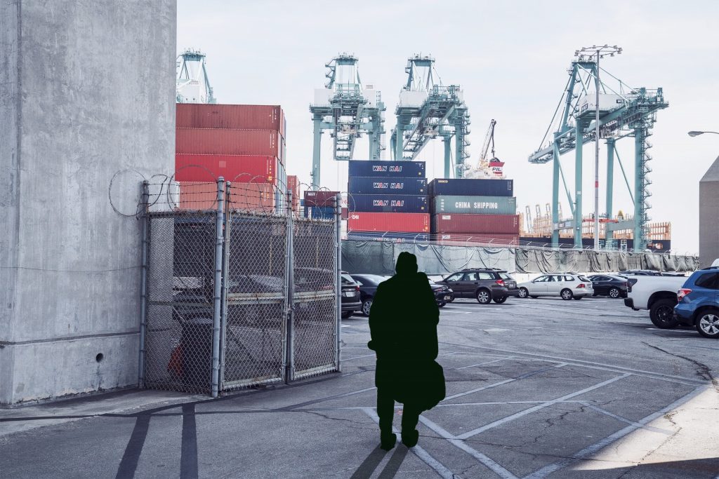 Unrecognizable man standing in cargo port