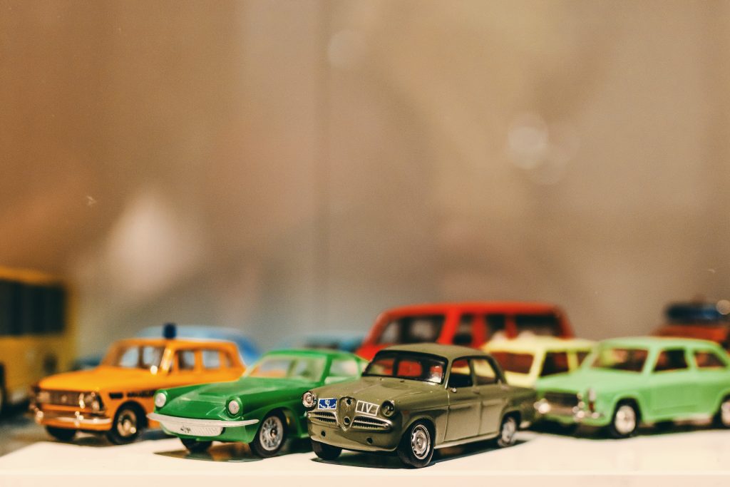 Assorted color toy car miniatures on white surface