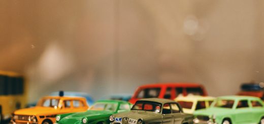 Assorted color toy car miniatures on white surface