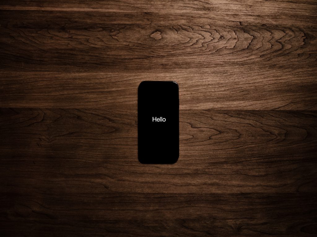 Turned on black iphone 7 displaying hello