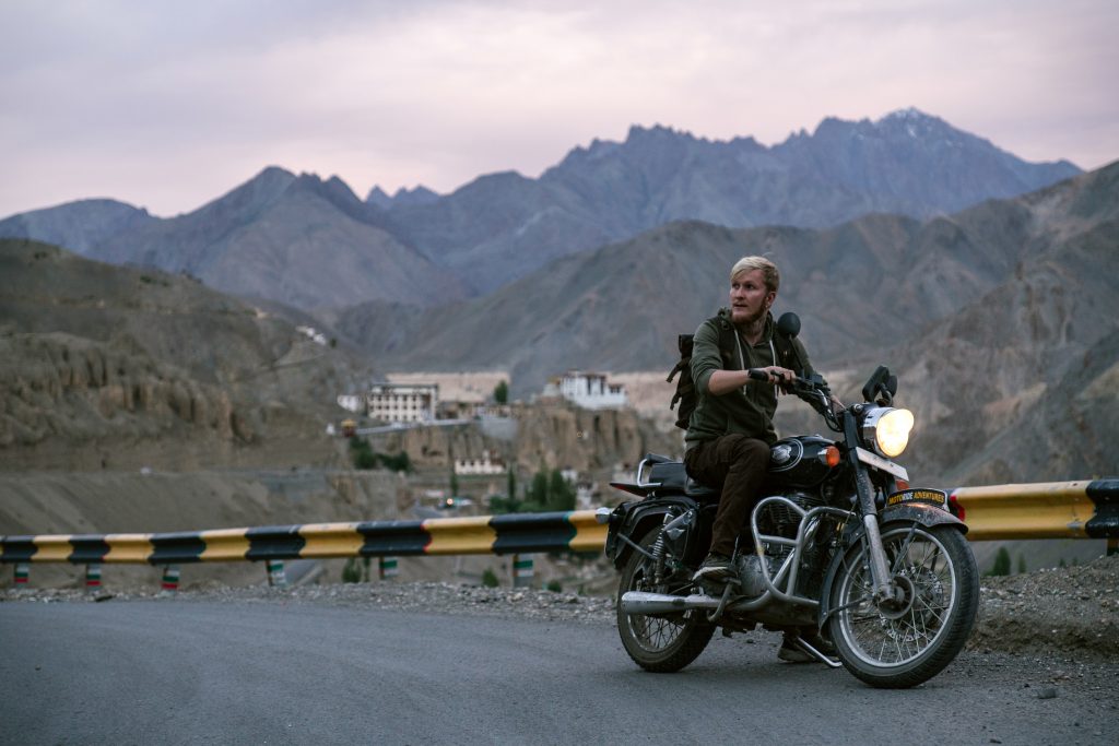 Man on motorcycle in rocky mountains