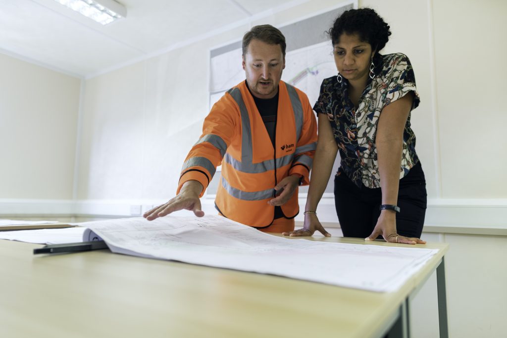 Engineers looking at blueprint